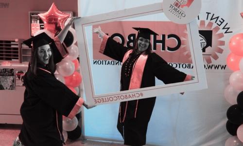 2 graduates posing for picture